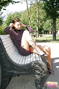 Cute Brunette Flashes Red Panties From Under Her Dress In The Park