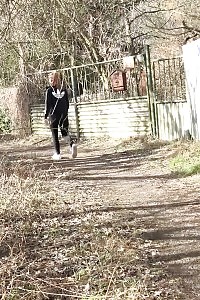 Naomi Benet Taking A Leek Near Abandoned Building